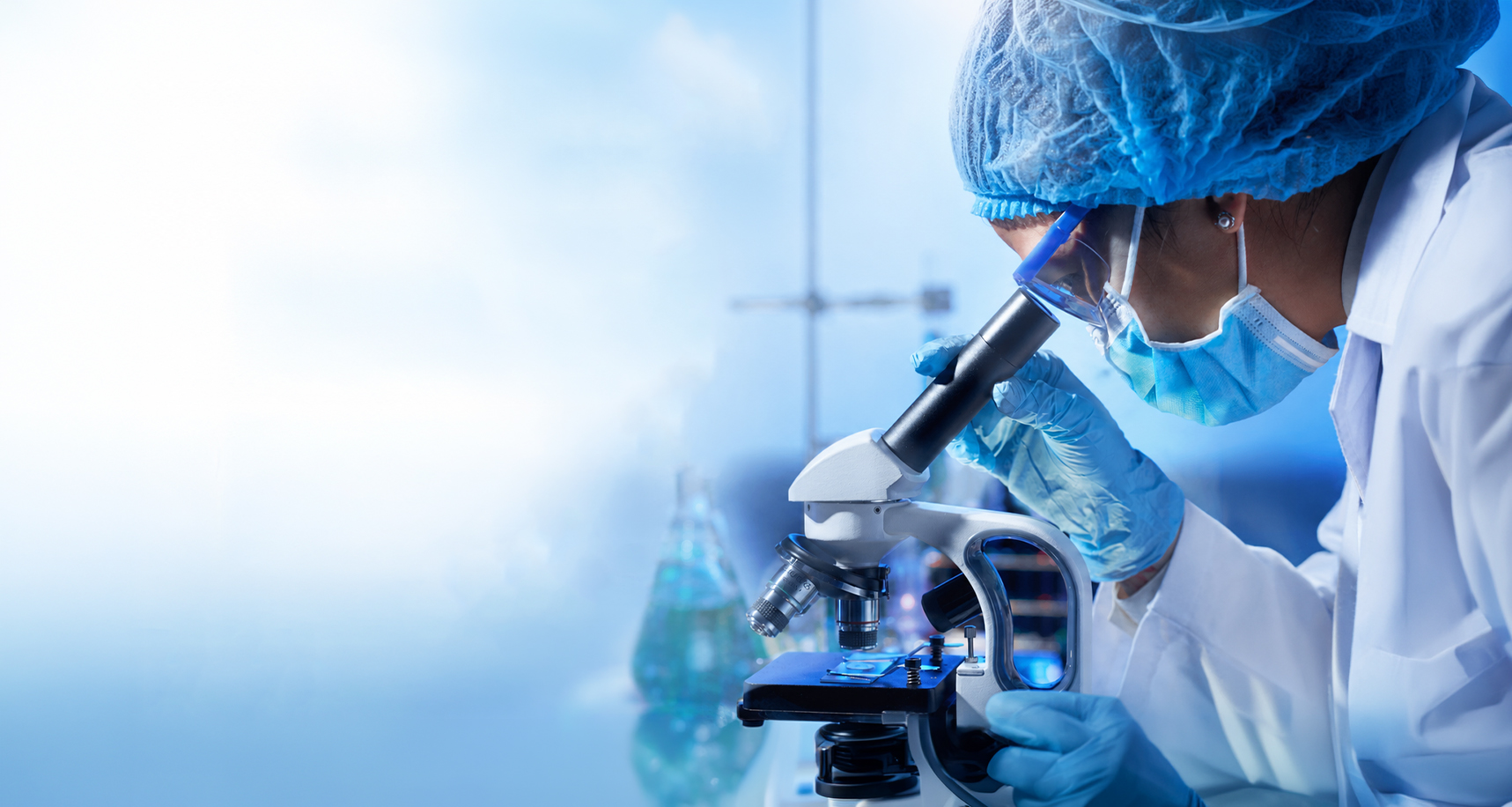 Scientist examining a sample under a microscope in a research lab